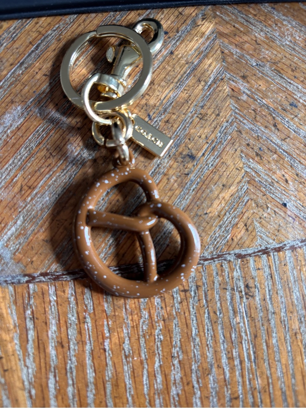 Gold-Tone Keychain with Brown Pretzel Charm and butterfly charm